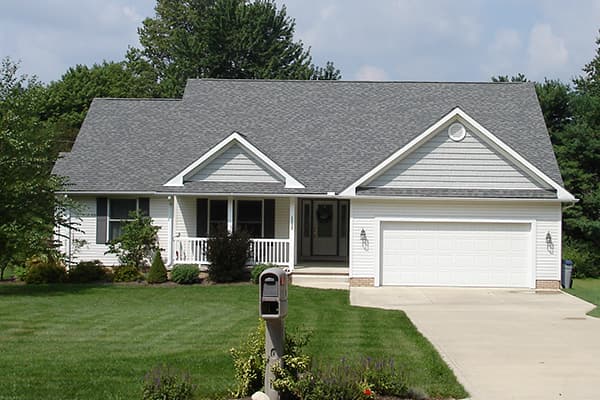 Pretty white single family home with grey roof